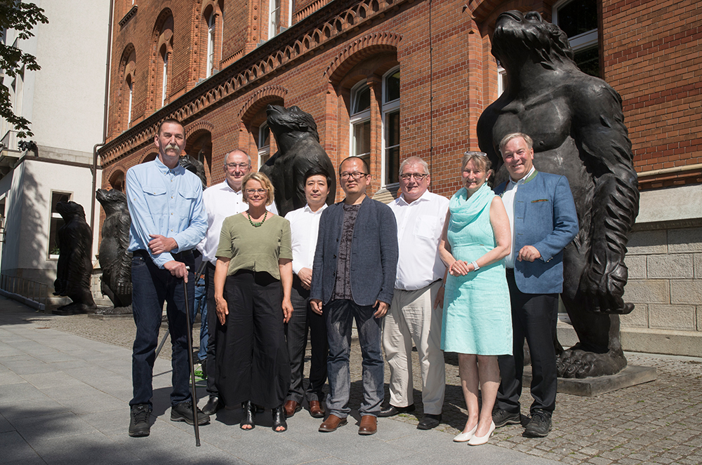 Bringing art and politics to one place: from left, Wolfgang Gramm (Chief Curator NordArt), Martin Behr (Kunstwerk Carlshütte), Inga Aru (Co-Curator NordArt), Wang Dong, Artist LIU Ruowang, President of the Landtag of Schleswig-Holstein Klaus Schlie, hosts at Kunstwerk Carlshütte Johanna and Hans-Julius Ahlmann